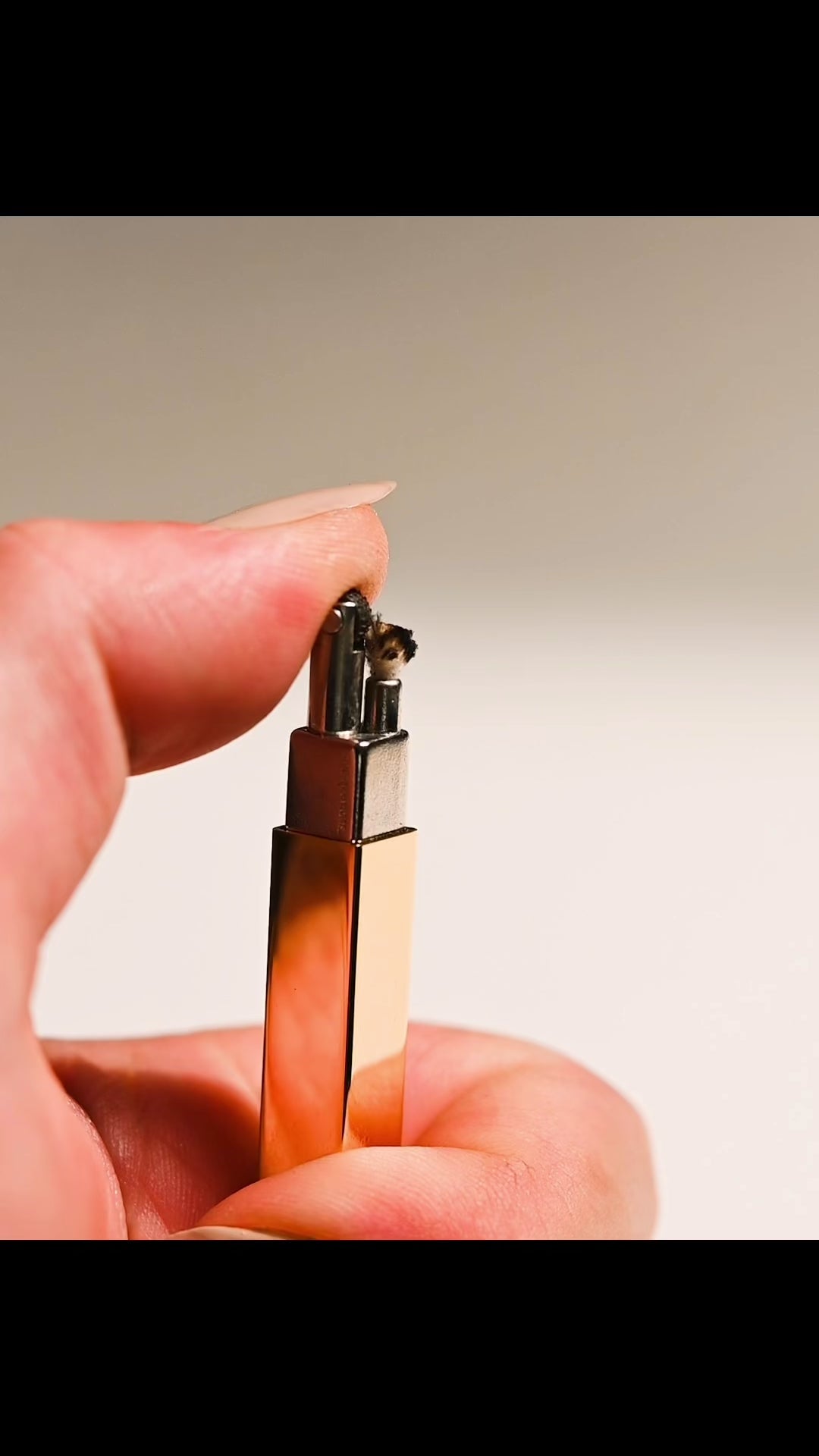 Close up video of hand lighting a Queue stick lighter and then lighting a Light Provisions candle