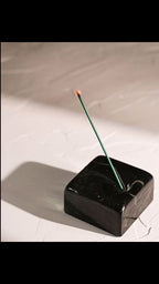 Incense burning then extinguishing in a black-blue recycled glass incense holder by IYE