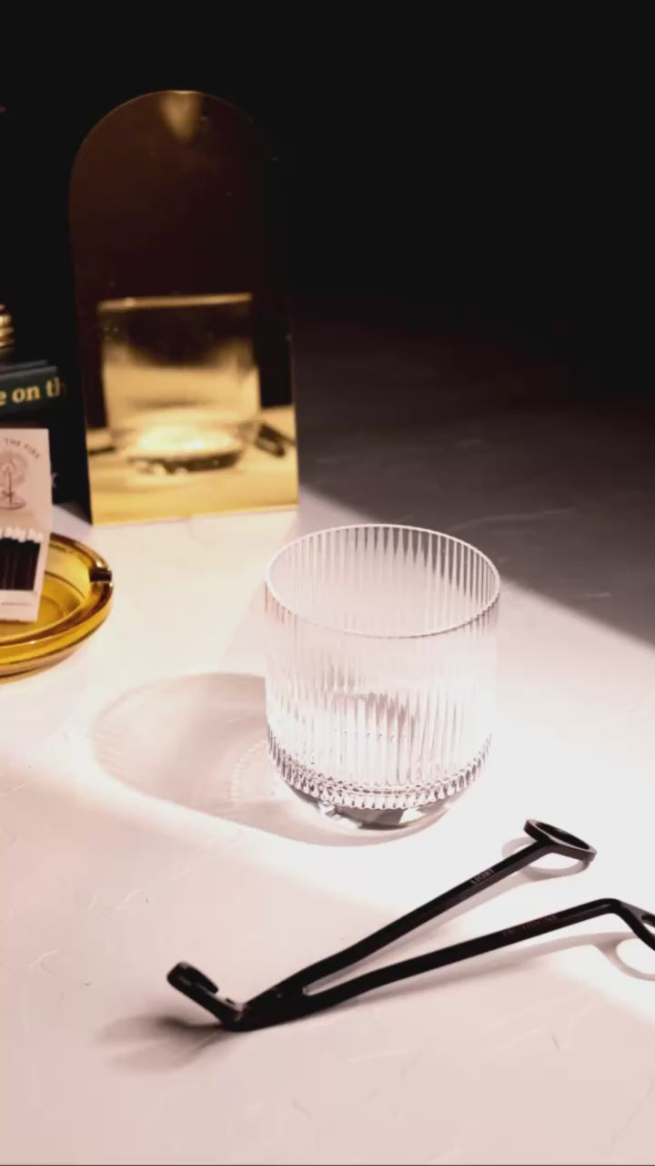 stop motion of hand lighting Light Provisions refill candle in a vintage vesel on a warm studio background