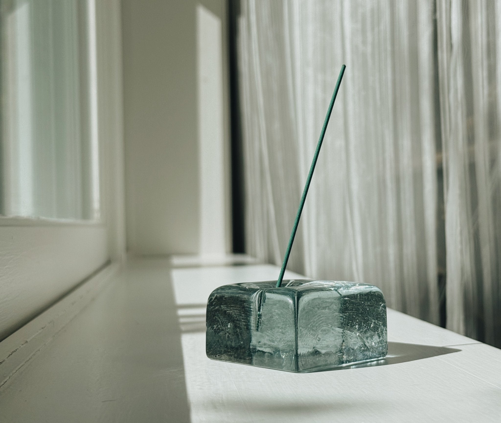 reborn recycled glass incense holder on warm ledge with coreless incense