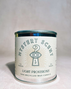 Candle with 'Mystery Scent' label on a light background