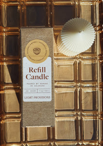 Patchouli Nutmeg Refill candle package with a shell on a gold textured background