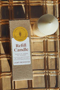 Harvest Refill candle with packaging on a gold textured background