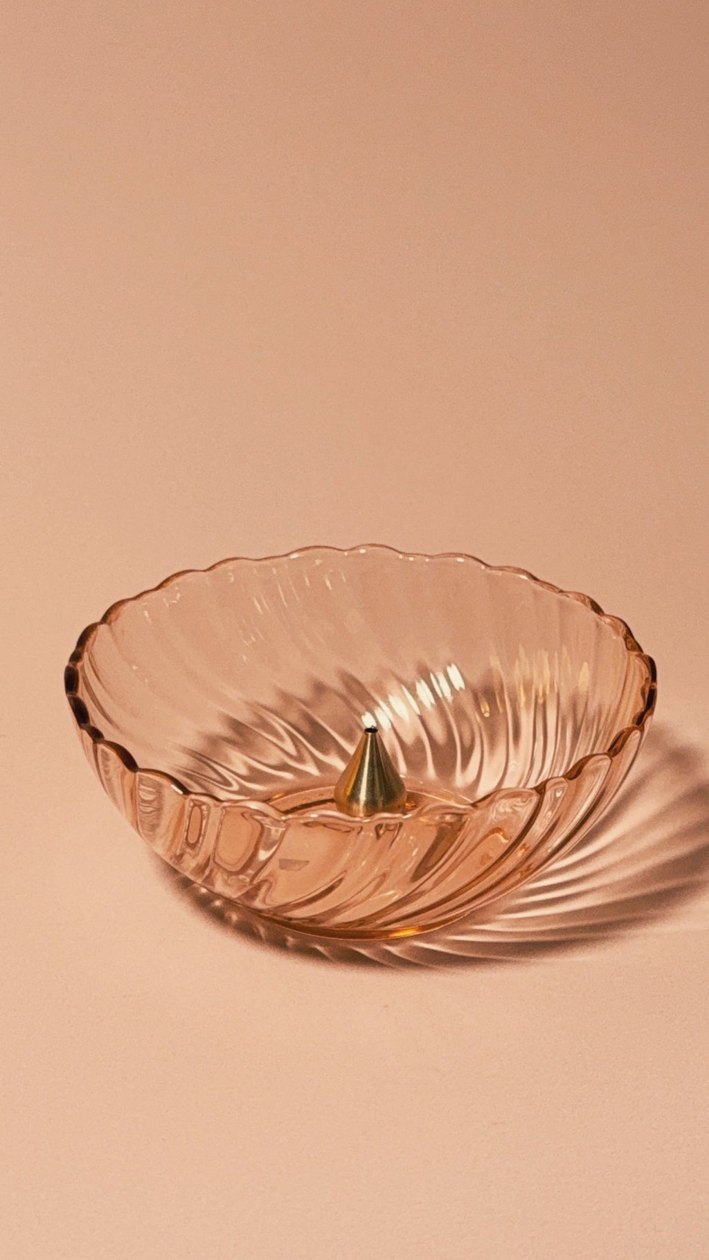 Vintage Rosaline Pink (Swirl Optic) by Cristal D’Arques–Durand with brass incense holder on beige background