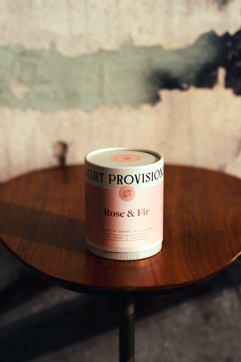 Close-up of Rose & Fir tube packaging on wooden table
