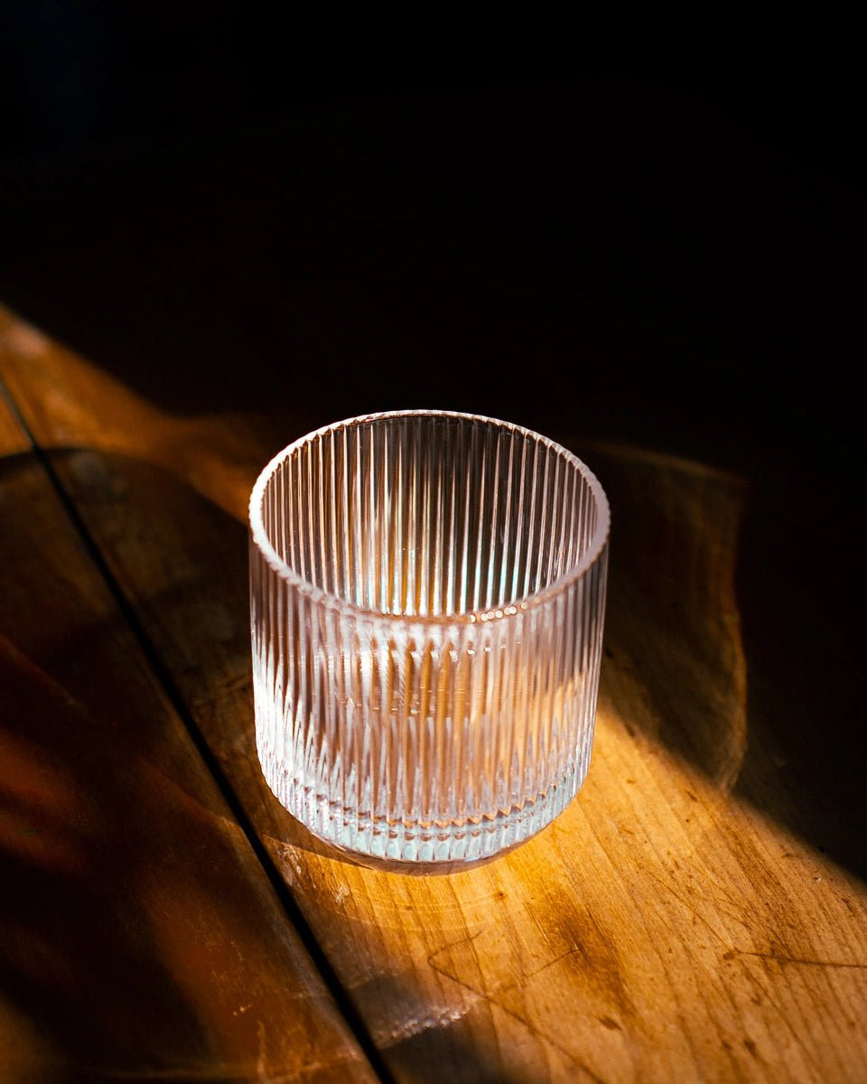 Handcrafted glassware with golden light shining through, made from lead-free crystal glass
