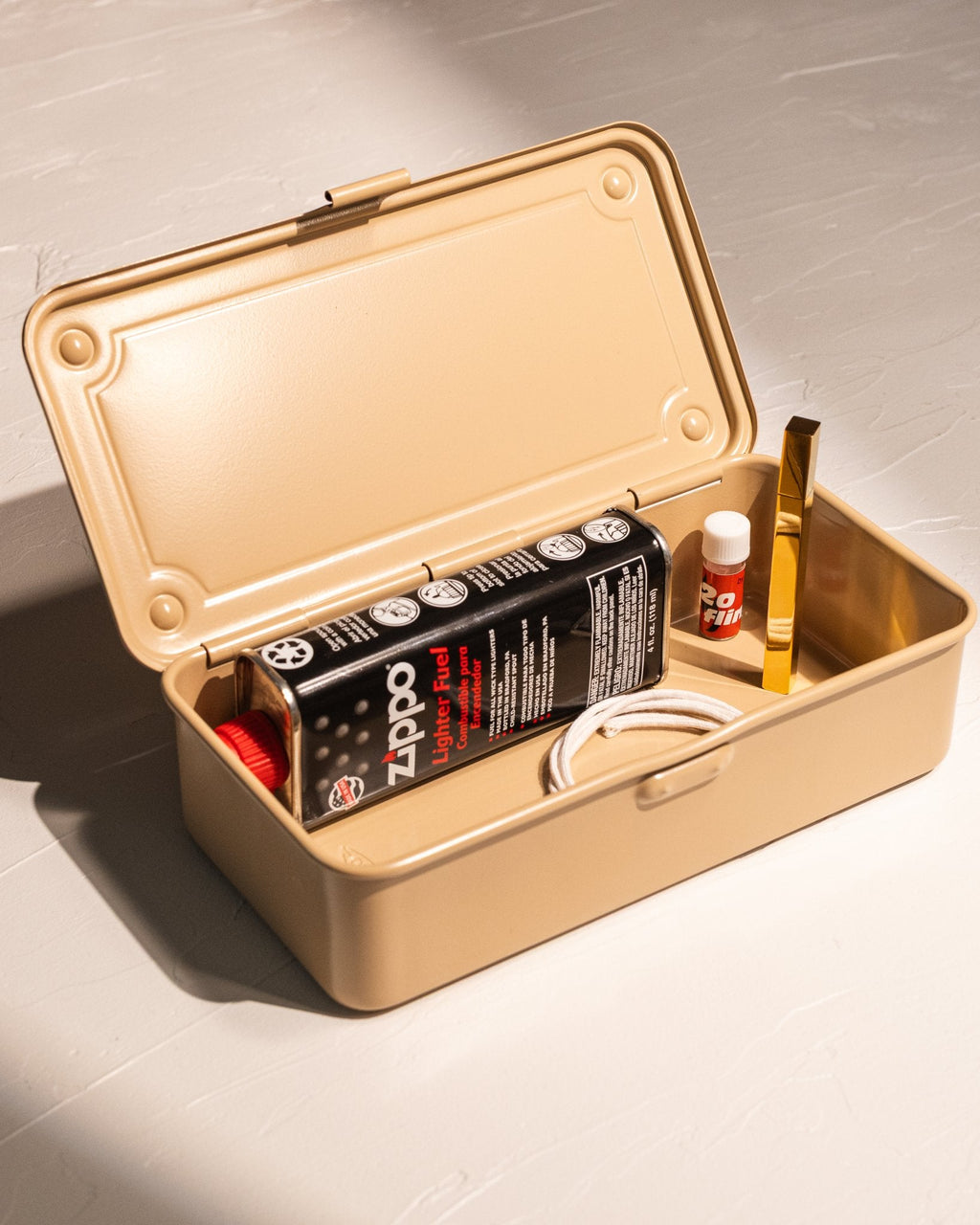 Open Toyo Steel T-190 storage box organizing lighter fluid, flints, and candle accessories