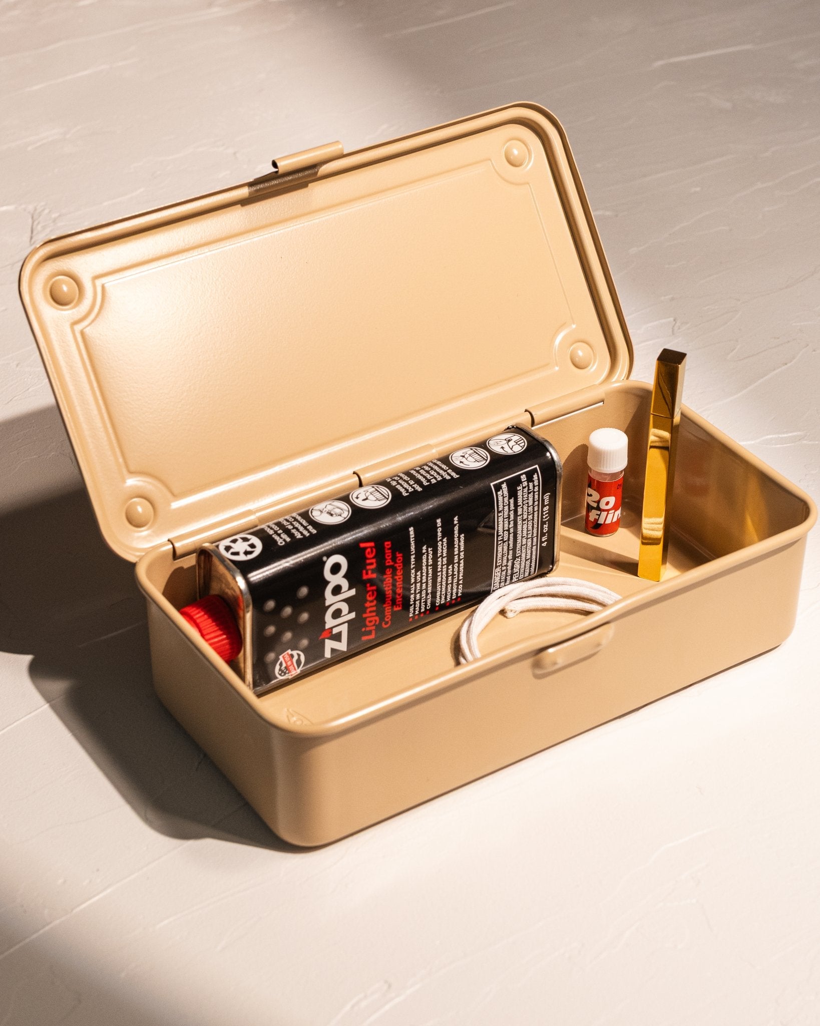 Open Toyo Steel T-190 storage box organizing lighter fluid, flints, and candle accessories