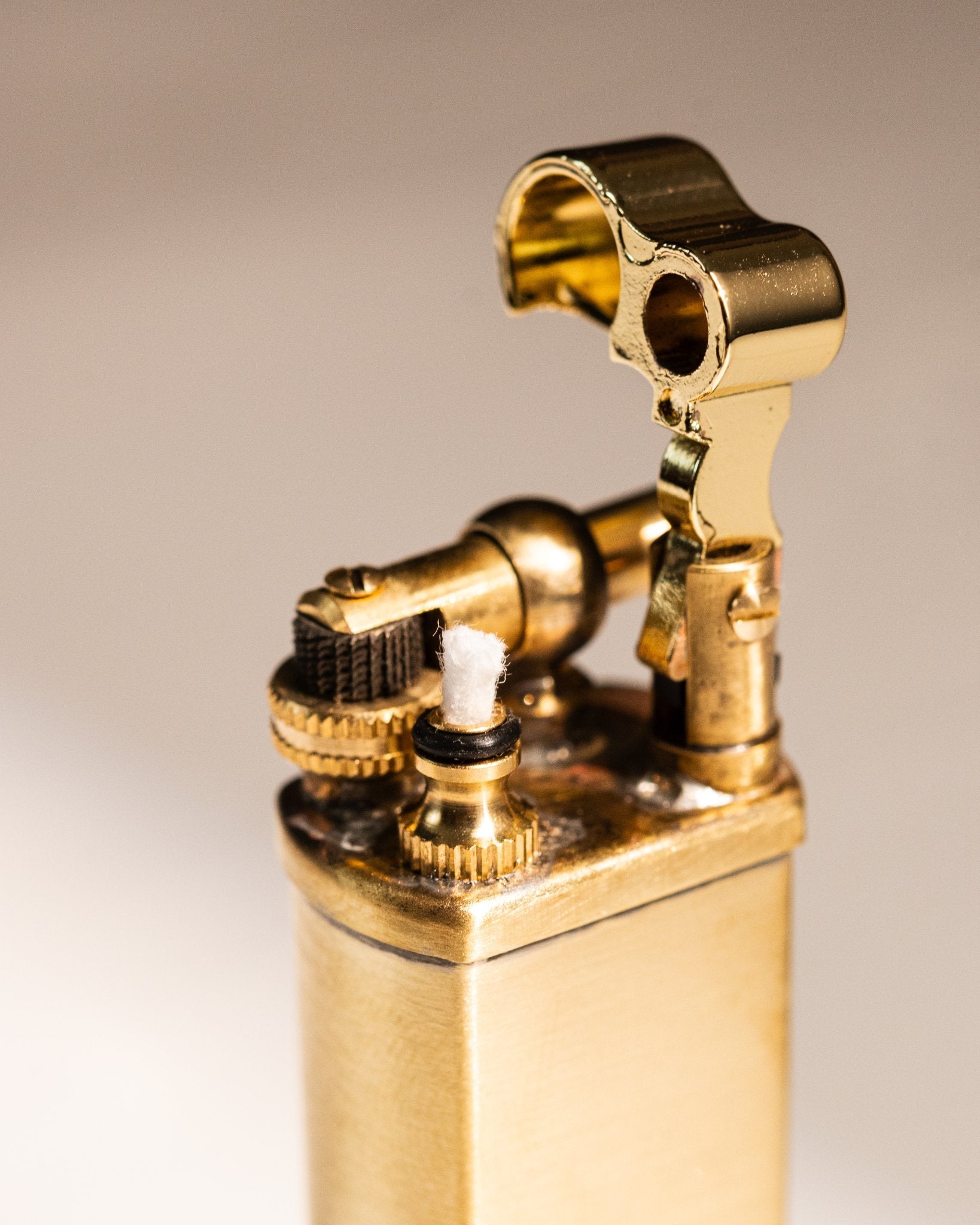 Detailed view of Tsubota Pearl Bolbo lighter hinge and flint wheel mechanism