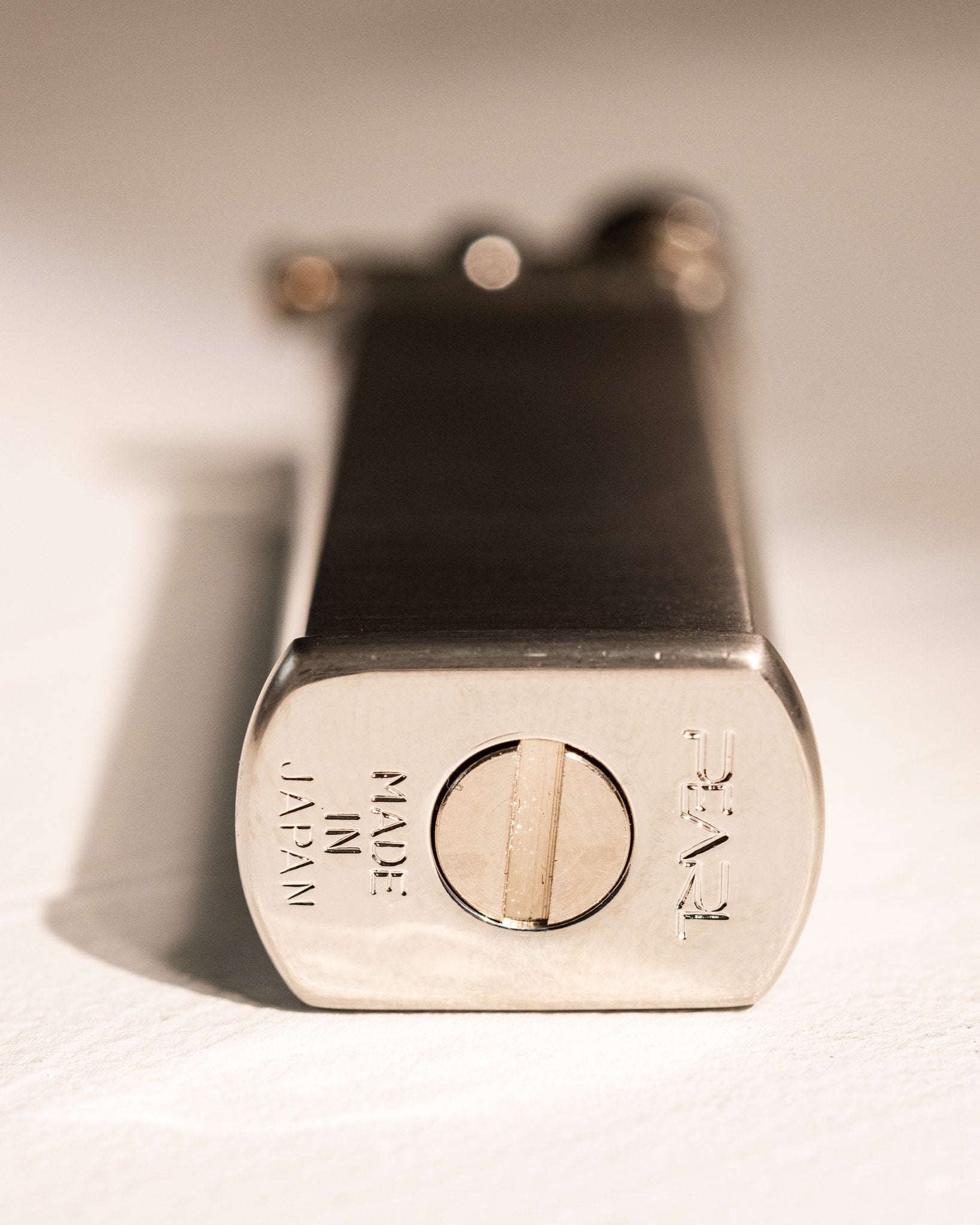 Base of silver Tsubota Pearl Bolbo lighter showing Japanese maker's mark