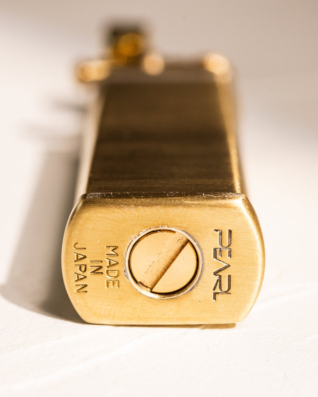 Base of gold Tsubota Pearl Bolbo lighter with "Pearl" and made in Japan engraving
