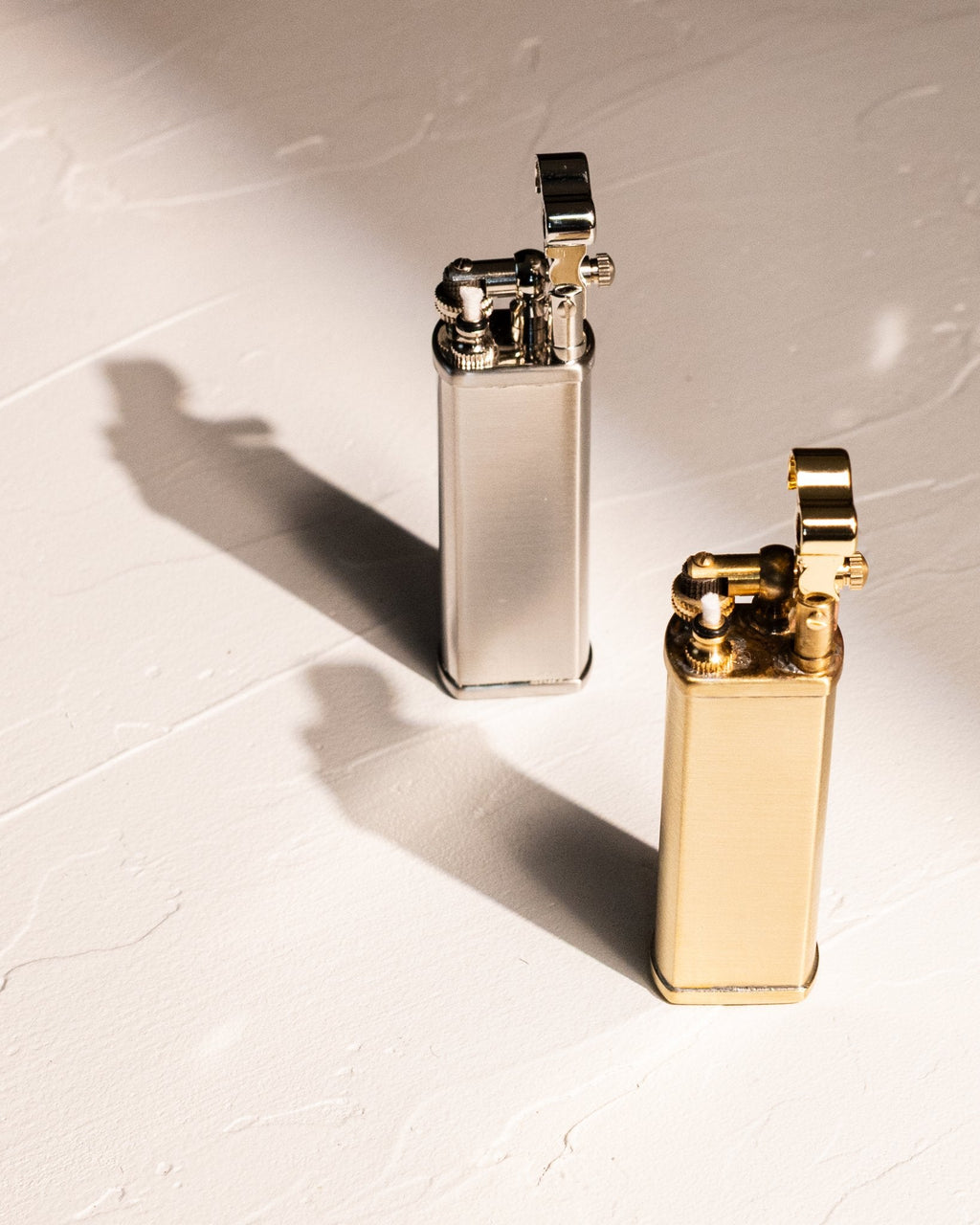 Tsubota Pearl Bolbo petrol lighters in silver and gold finishes, made in Japan