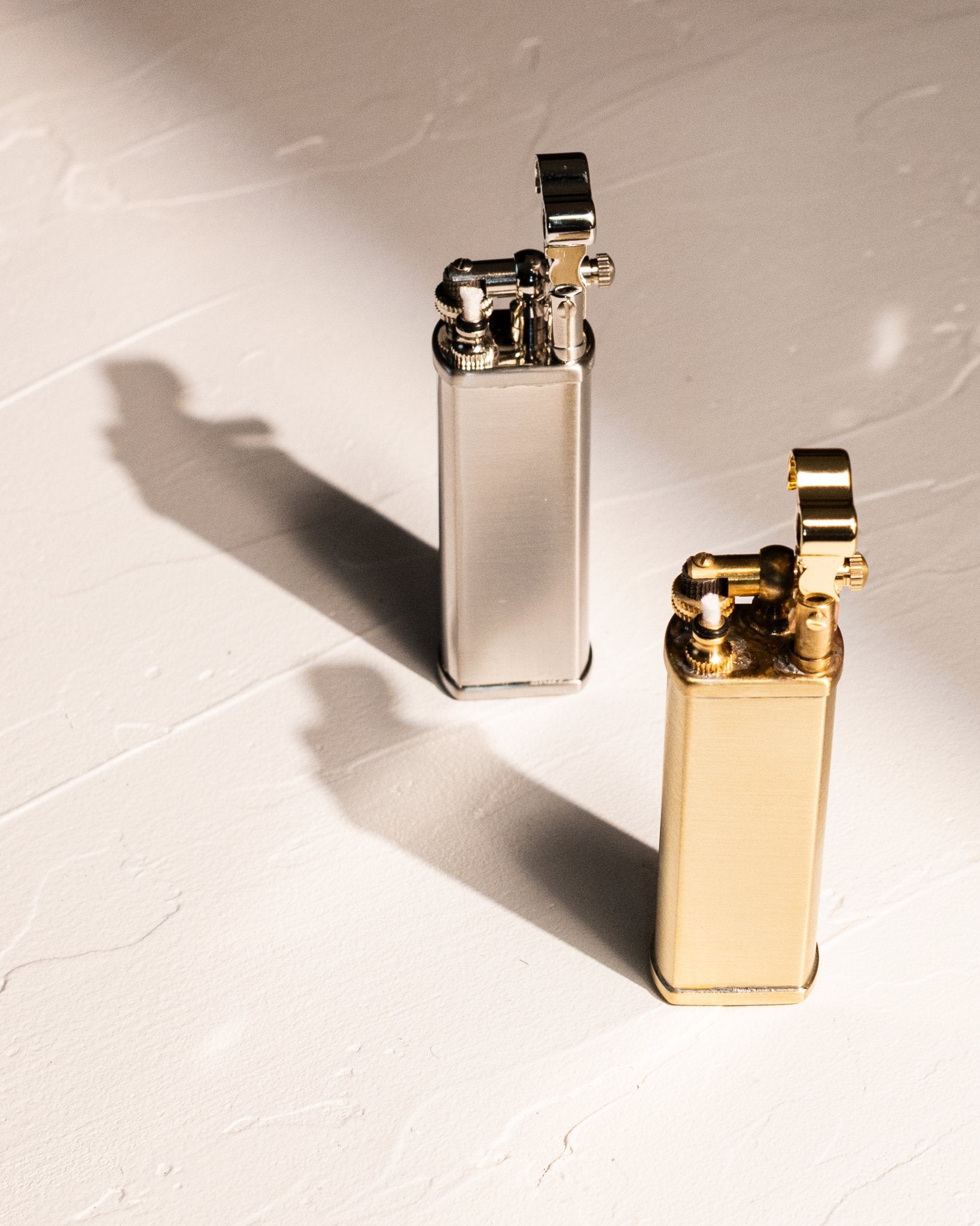 Tsubota Pearl Bolbo petrol lighters in silver and gold finishes, made in Japan