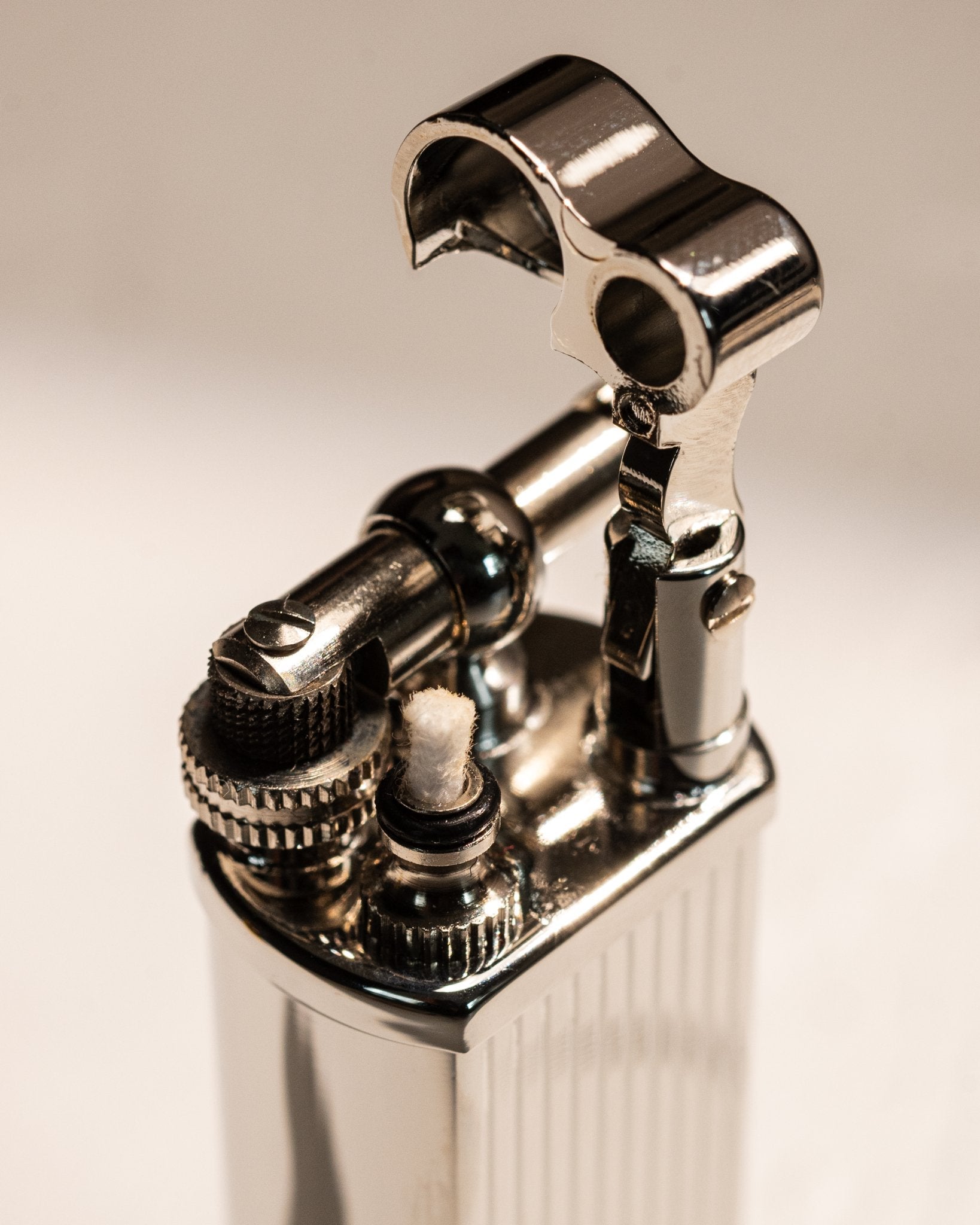 Close-up of silver Bolbo Striped lighter ignition assembly and windscreen