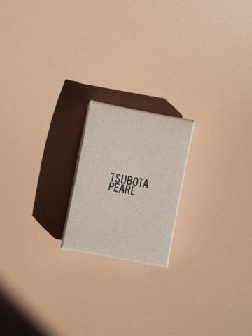 Tsubota Pearl Bolbo lighter retail box shown alone, photographed on a neutral background.
