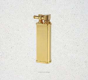 Gold lighter on a textured white background