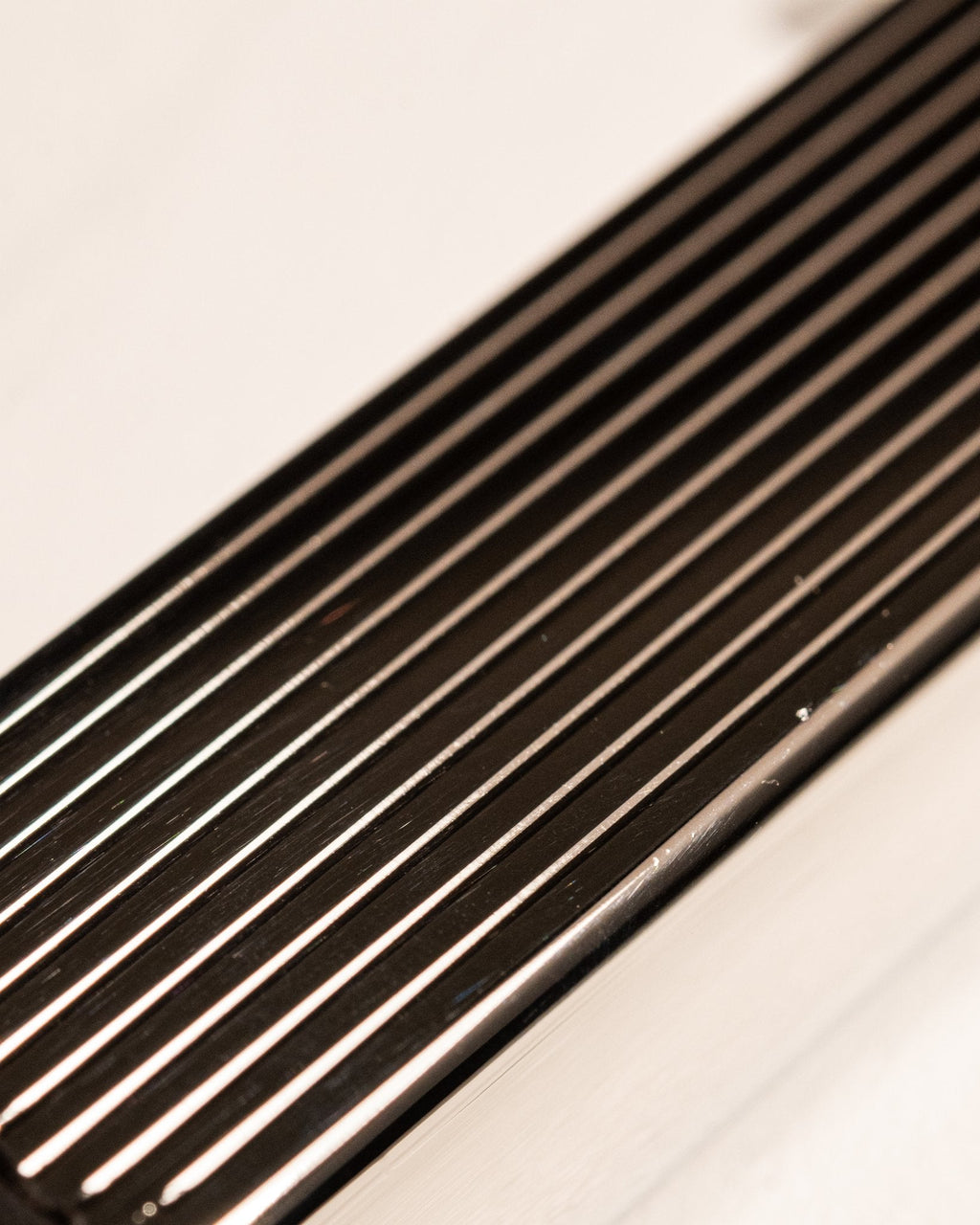 Close-up of silver Bolbo Striped lighter showing precision fluted metalwork