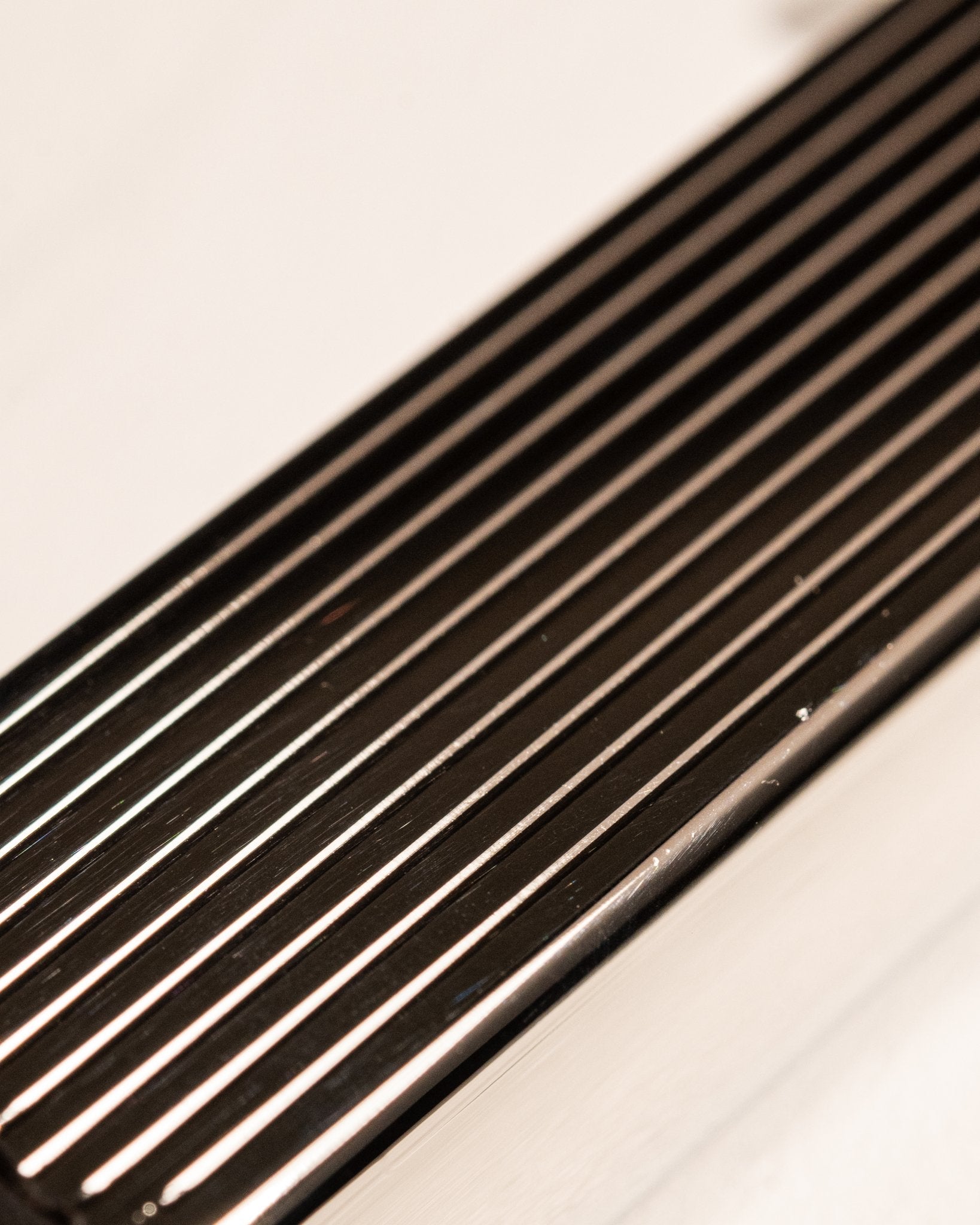 Close-up of silver Bolbo Striped lighter showing precision fluted metalwork