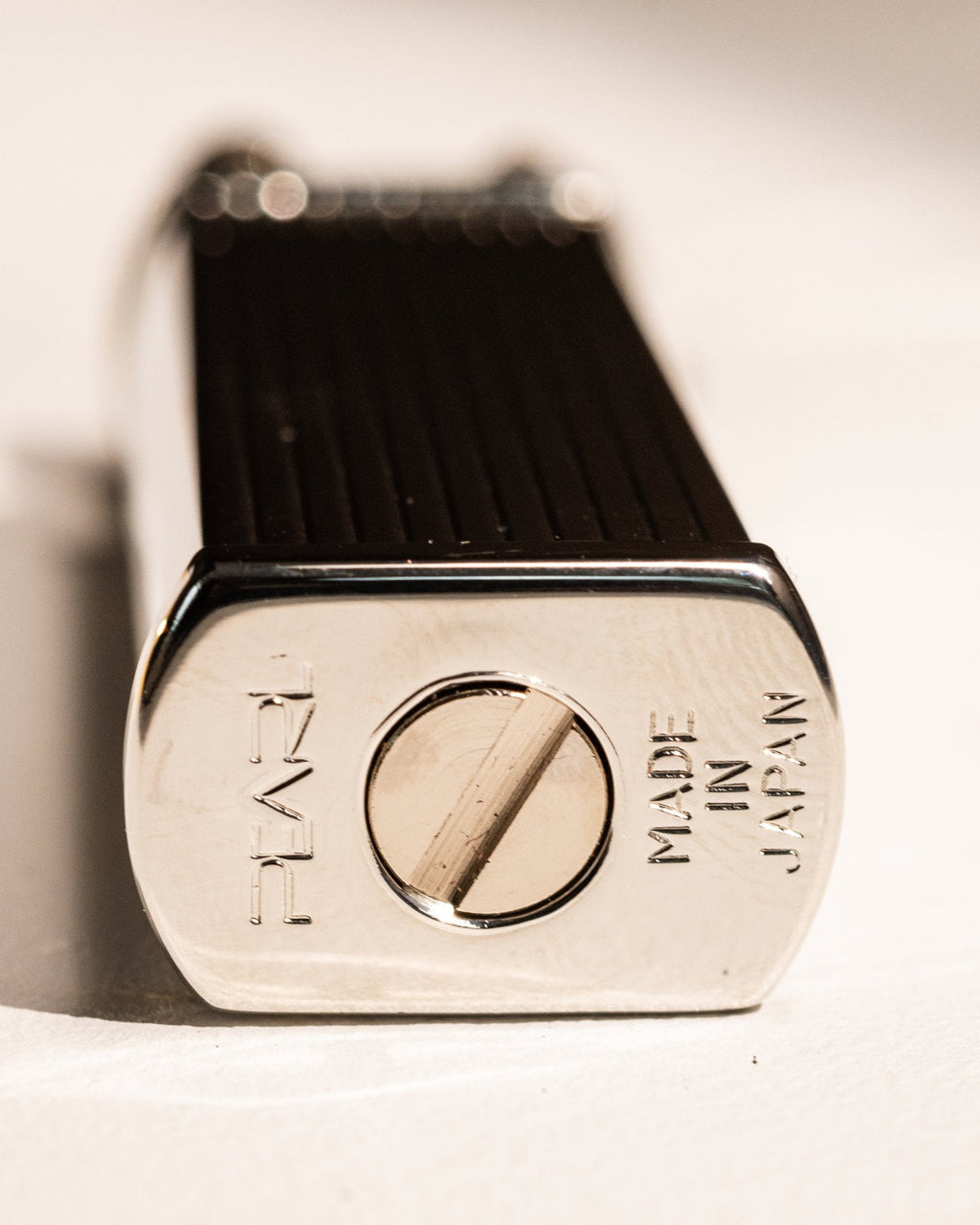 Base of silver Tsubota Pearl Bolbo Striped lighter with Japanese maker's mark
