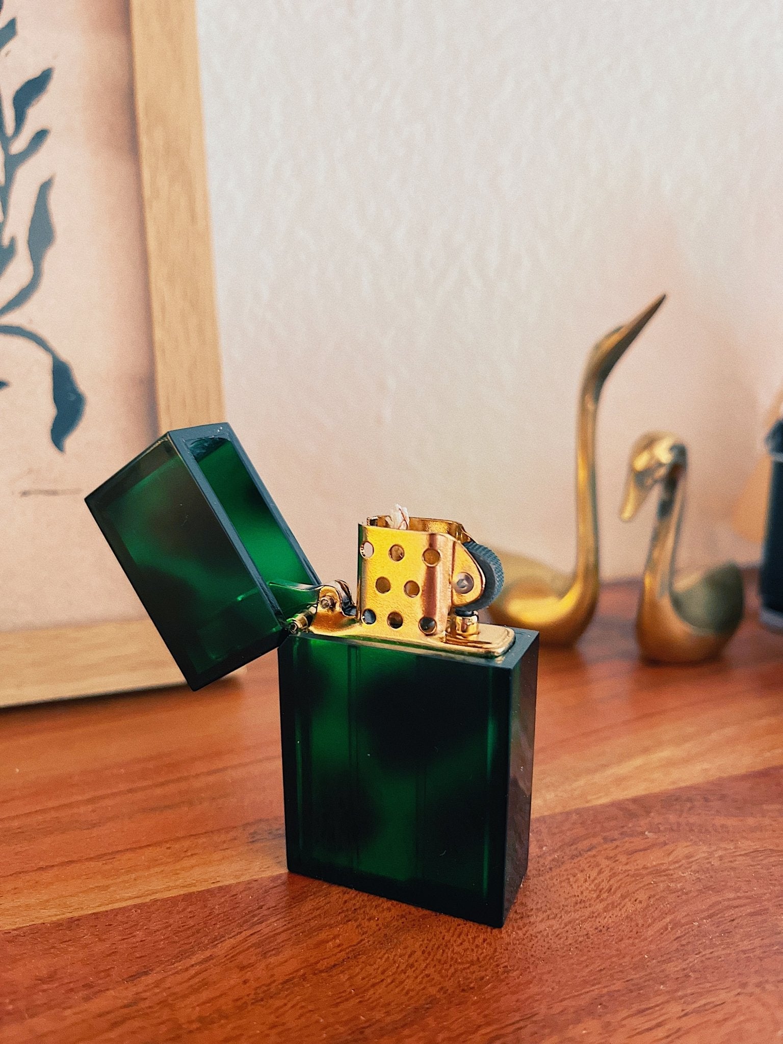 Green lighter with brass accents in home setting