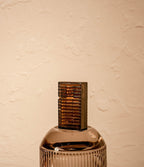 Black Latitude lighter with diamond-cut case on glass surface