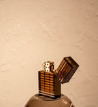 Black Tsubota Pearl Latitude lighter with lid open and gold interior body