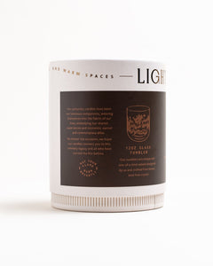 Side view of Tobacco & Walnut flagship candle box showing gold foil logo,  label, about us copy, and copy describing glass.