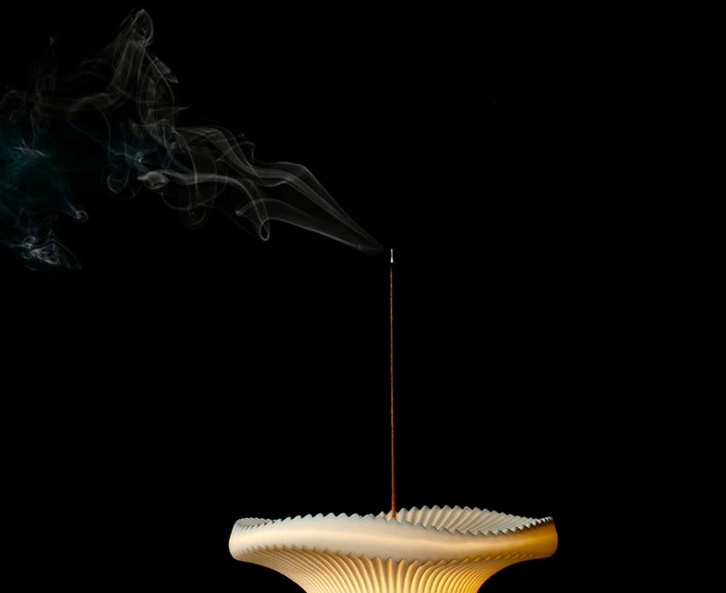 Vision sculptural incense holder light with rising incense smoke and illuminated ceramic surface