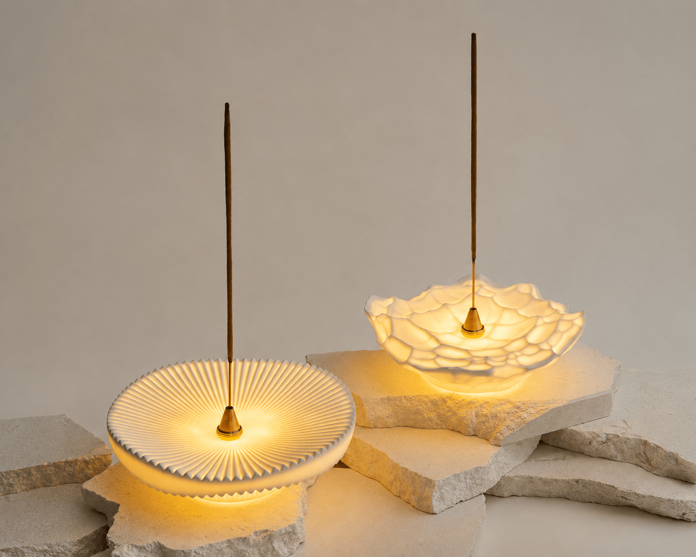 Vision and Gem sculptural incense holder lights illuminated on stone slabs with brass incense holders