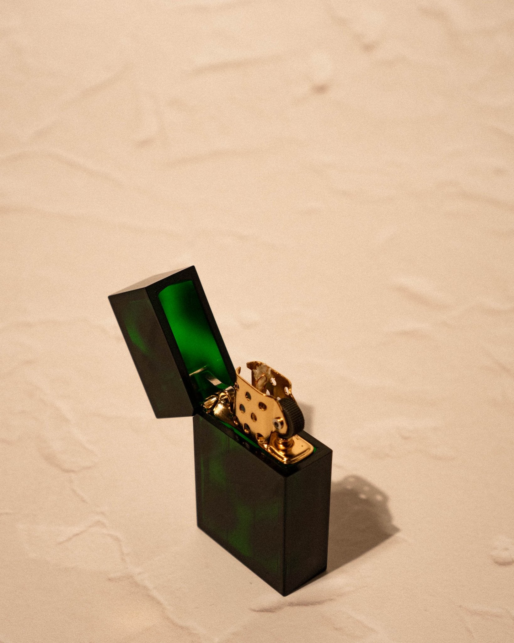Tsubota Pearl Hard-edge Lighter marble green emerald pattern angled open on neutral surface, made in Japan