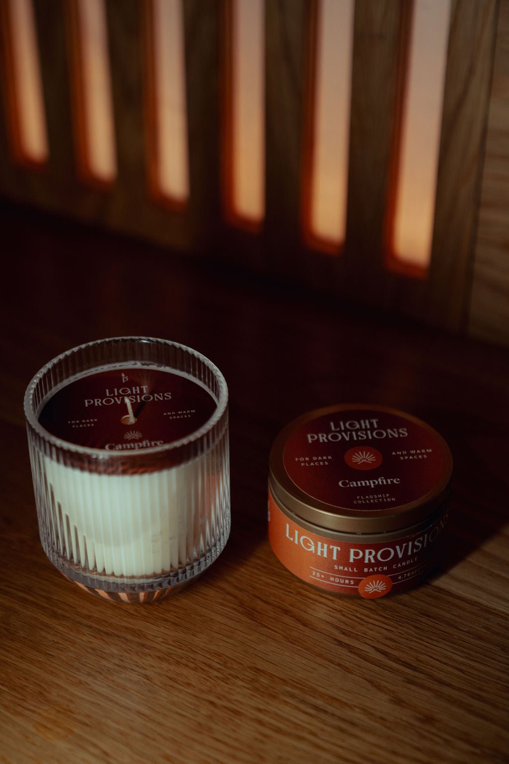  Light Provisions Campfire candle set with ribbed glass tumbler and gold travel tin, placed on wood with warm lighting.