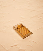 Clear Tsubota Pearl Latitude lighter with lid closed and laying on face