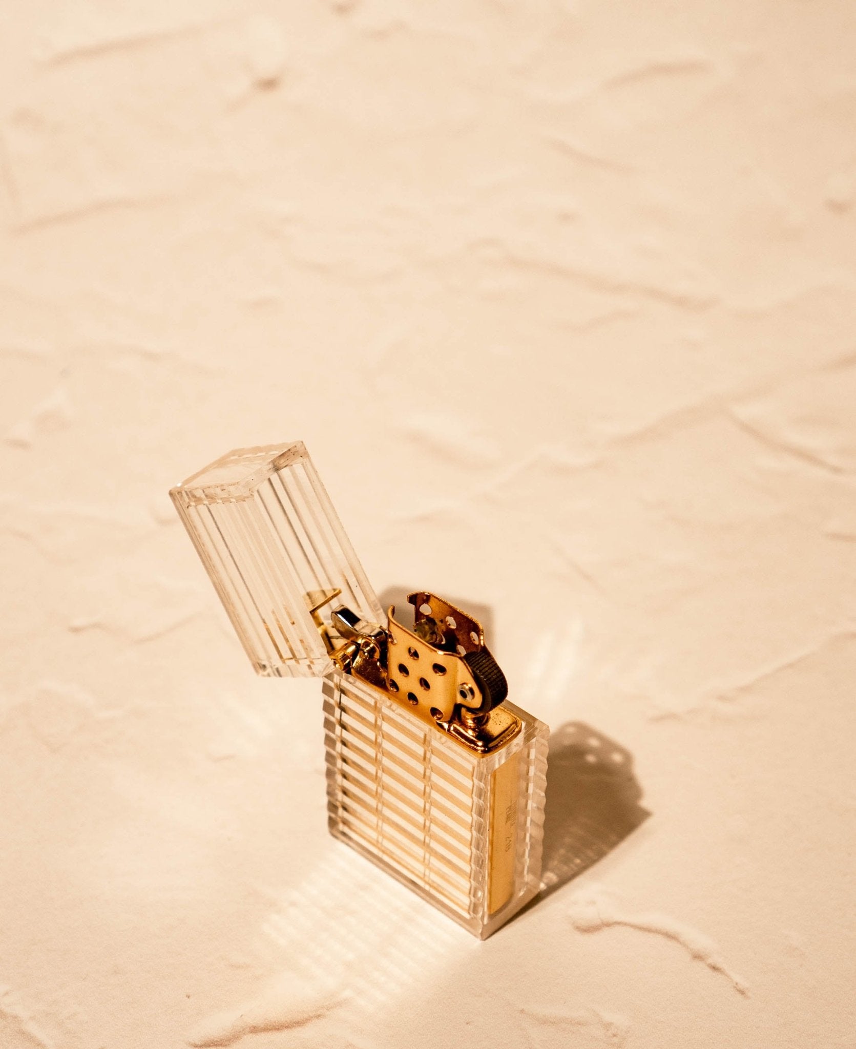 Latitude Hard-edge Lighter by Tsubota Pearl in clear ridged-cut design with gold brass interior, made in Japan