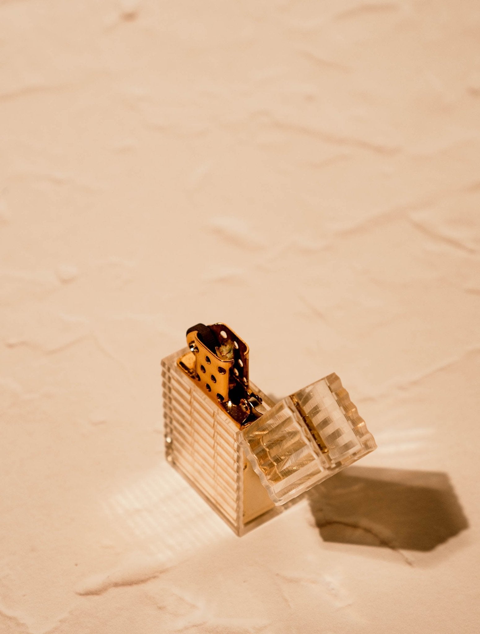 Latitude Hard-edge Lighter by Tsubota Pearl standing upright, clear ridged-cut with gold brass interior, made in Japan