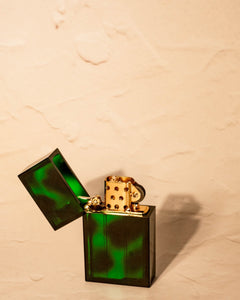 Open Tsubota Pearl Hard Edge lighter in translucent forest green finish, flint wheel and windguard visible