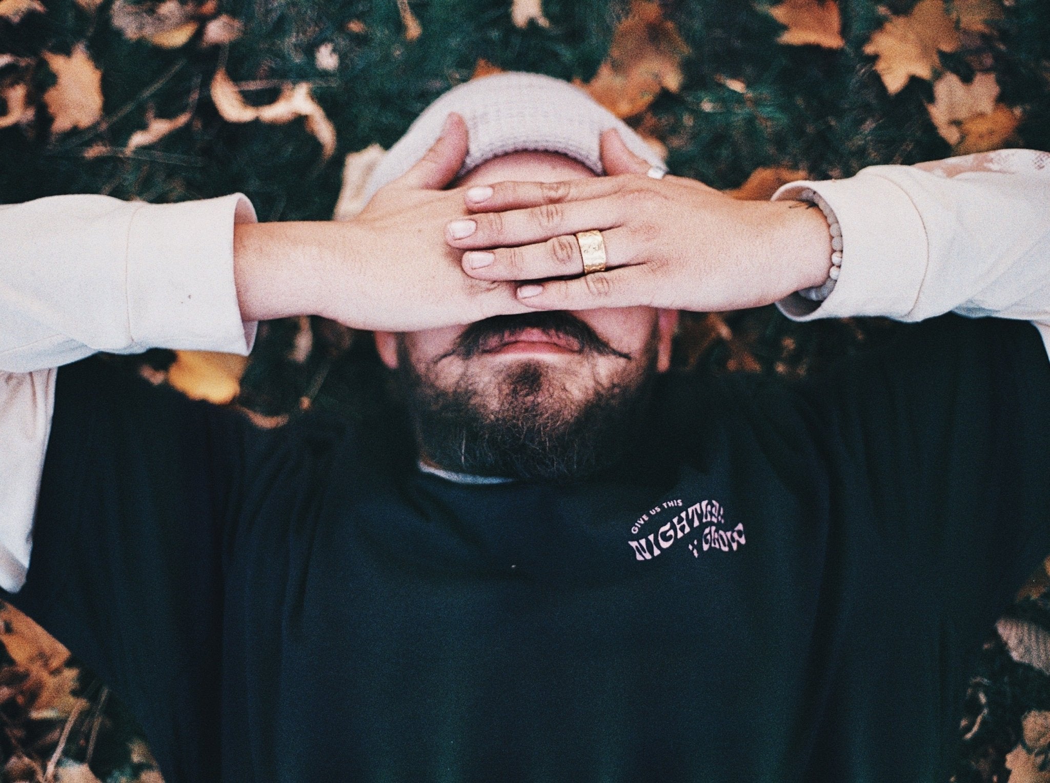 Front of Light Provisions moth shirt with Give us this nightly glow text.