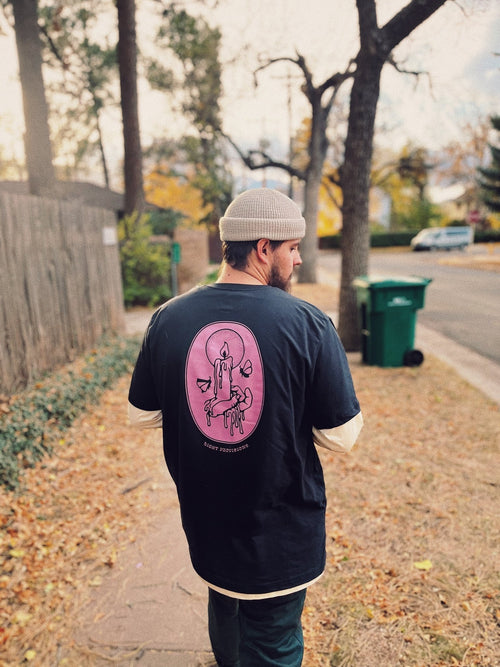 Model wearing Light Provisions moth graphic t-shirt outdoors.