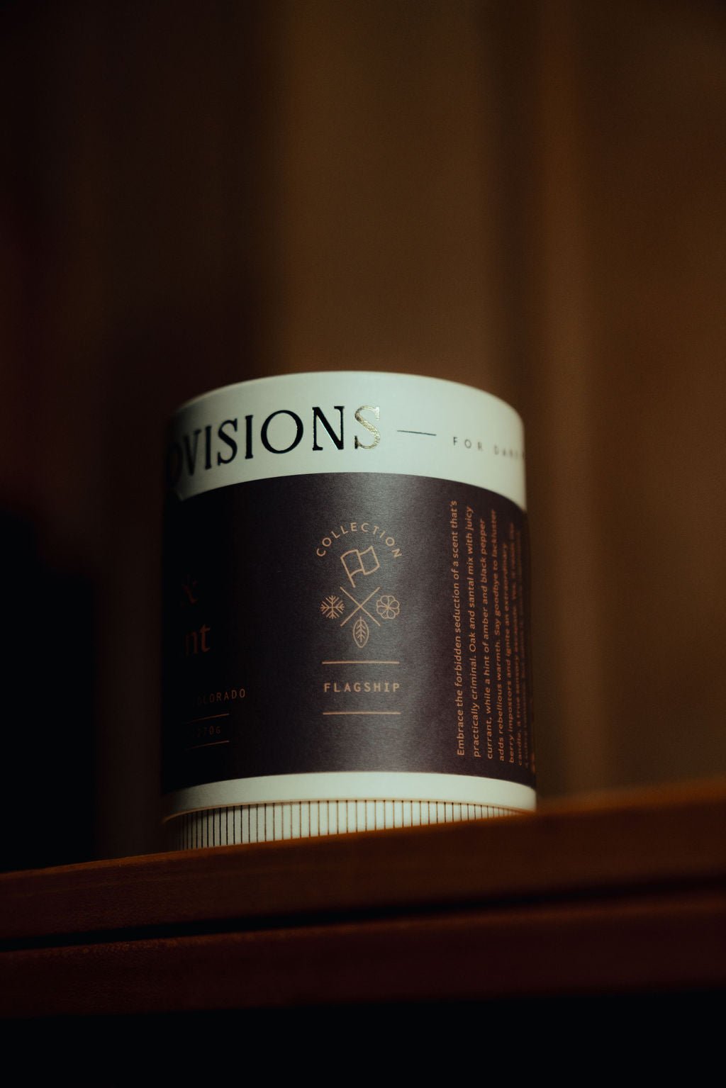 Premium paper tube packaging for Oak and Currant Candle shown upright on wooden table