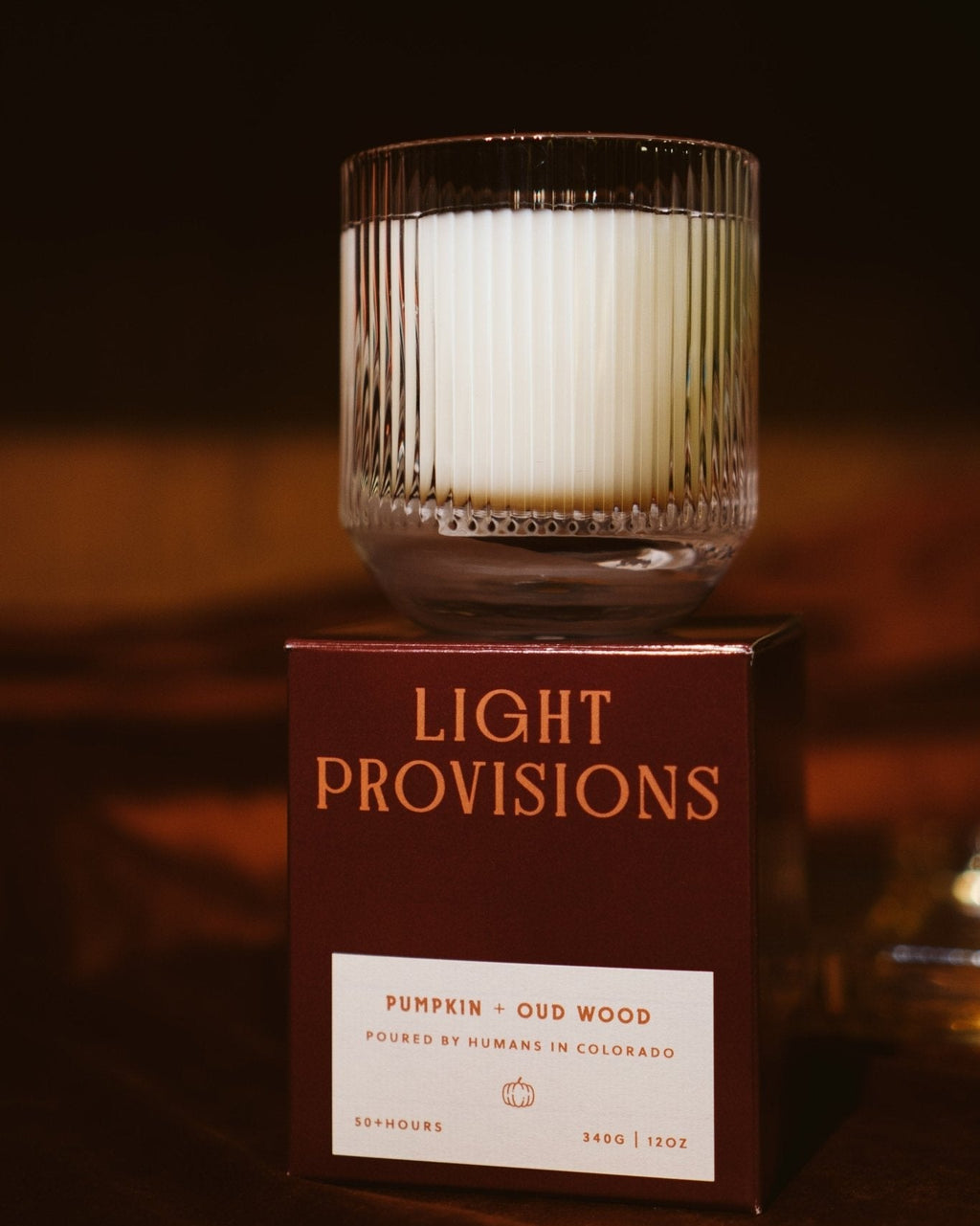 Pumpkin & Oud Wood Candle sitting on custom packaged Light Provisions box