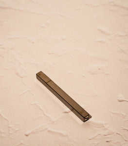 Tsubota Pearl Queue lighter in polished black finish, resting on neutral surface