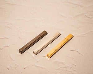 Array of 3 stick lighters: black, silver, gold, resting on side with bottom screws visible (for repair and refilling)