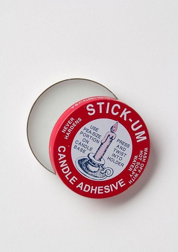 Top down view and open lid of Stickum Candle Adhesive - for securing beeswax tapers and refill candles safely in holders on white background